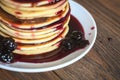 Stack of pancakes white plate with cherry jam, red napkin, brow Royalty Free Stock Photo
