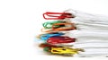 Stack of paper documents held together by colorful paperclips Royalty Free Stock Photo