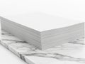 Stack of paper on marble surface  on white background Royalty Free Stock Photo