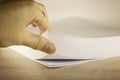 Stack of paper on office desk for report papers . Close up of stack paper. Females hand touching paper, close up view