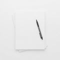 Stack of paper with pen isolated on white background Royalty Free Stock Photo