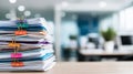 Stack of papers with colorful binder clips on a desk in a modern office, representing administration and documentation Royalty Free Stock Photo