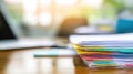 Stack of papers on desk with laptop blurred background Royalty Free Stock Photo
