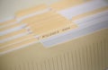 A stack of papers in filing cabinet with inscription Royalty Free Stock Photo