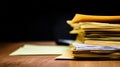 Stack of papers and folders on wooden desk against black background Royalty Free Stock Photo
