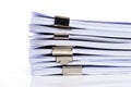 A stack of papers held together by binder clips isolated on a white background isolated on white background Royalty Free Stock Photo