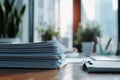 A stack of papers sitting on a wooden table, possibly for reading or writing Royalty Free Stock Photo