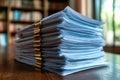 A stack of papers sitting on a wooden table, ready for work or study Royalty Free Stock Photo
