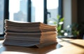 Stack of papers on wooden desk with sunlight streaming through window, creating Royalty Free Stock Photo