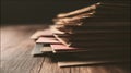 Stack of papers on wooden surface with warm lighting Royalty Free Stock Photo