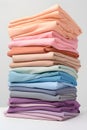 Stack of pastel colored clothes folded. Delicate color shades variations.