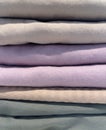 A Stack of Pastel Colored Pillowcases