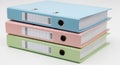 Stack of pastel colored ring binders for organizing documents files and paperwork Royalty Free Stock Photo