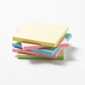 Stack of pastel-colored sticky note pads on a white background. The pads are square, Royalty Free Stock Photo