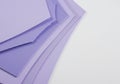 Stack of pastel purple paper sheets arranged diagonally, creating a layered effect. The Royalty Free Stock Photo