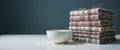 Stack of Patterned Textiles Beside a Bowl Royalty Free Stock Photo