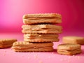 Stack of peanut butter cookies on a pink background