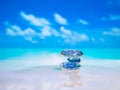 Stack of pebble stones and Plumeria at the beach on a wooden surface. Concept Zen, Spa, Summer, Beach, Sea, Relax Royalty Free Stock Photo