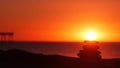 Stack of pebble stones, sandy ocean beach, sunset sky. Rock balancing by water. Royalty Free Stock Photo