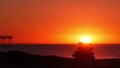 Stack of pebble stones, sandy ocean beach, sunset sky. Rock balancing by water. Royalty Free Stock Photo