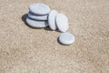 Stack of pebble stones unbalanced on a sandy beach Royalty Free Stock Photo