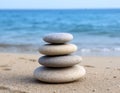 A stack of pebbles on a beach with a blurred ocean background Royalty Free Stock Photo
