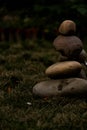 Stack of pebbles on the grass in the garden at night Royalty Free Stock Photo