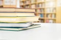Stack and pile of books on table in public or school library. Royalty Free Stock Photo