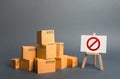 A stack pile cardboard boxes and a sign stand with red symbol NO. Restriction on the importation of goods, proprietary