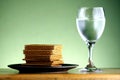 Stack or pile of crackers and a goblet of water