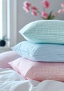 a stack of pillows. pillowcases in pastel blue, pink, mint colors with small checks and stripes on a white background of
