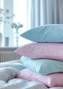 a stack of pillows. pillowcases in pastel blue, pink, mint colors with small checks and stripes on a white background of