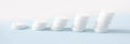 A stack of pills on a blue background. Growth graph made of stacked white pills - growing market and increasing demand for white Royalty Free Stock Photo