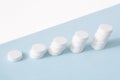 A stack of pills on a blue background. Growth graph made of stacked white pills - growing market and increasing demand for white Royalty Free Stock Photo