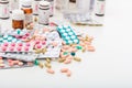 Stack of pills and containers on white background Royalty Free Stock Photo