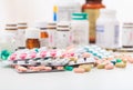 Stack of pills and containers on white background Royalty Free Stock Photo