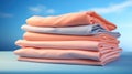 Stack of pink and blue folded clothes on blue background. Peach Fuzz color Royalty Free Stock Photo