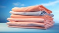 Stack of pink and blue folded clothes on blue background. Peach Fuzz color