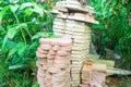 Stack of pink concrete floor tiles in garden. Pile of red and gray paving stone for patio Royalty Free Stock Photo