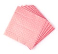 Stack of pink dotted paper napkins on white background