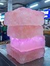 Stack of pink ice blocks on a metal surface Royalty Free Stock Photo