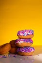 A stack of pink sprinkle donuts