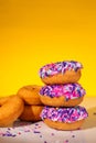 A stack of pink sprinkle donuts