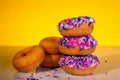 A stack of pink sprinkle donuts