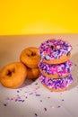 A stack of pink sprinkle donuts