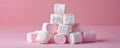 Stack of pink and white marshmallows on pink background, sweet dessert concept Royalty Free Stock Photo