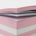 Stack of pink and white paper sheets isolated on white background Royalty Free Stock Photo