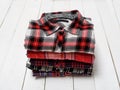 Stack of plaid shirts on a white wooden background. Clothing concept Royalty Free Stock Photo