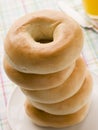 Stack of Plain Bagels with a Glass of Orange Juice Royalty Free Stock Photo