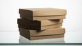 Stack of plain brown cardboard boxes on a reflective surface against a white background Royalty Free Stock Photo